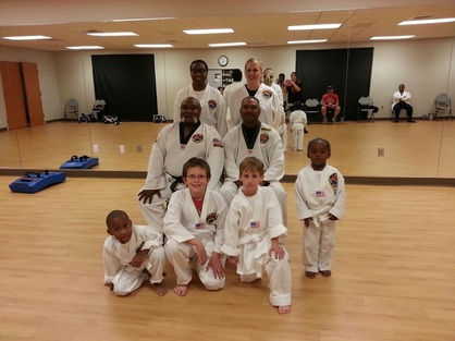 Pictured are some of the Anniston, Alabama students.  Seated from left to right are Junior Grand Master Lewis and Alabama Head Instructor Mr. Marcus King.